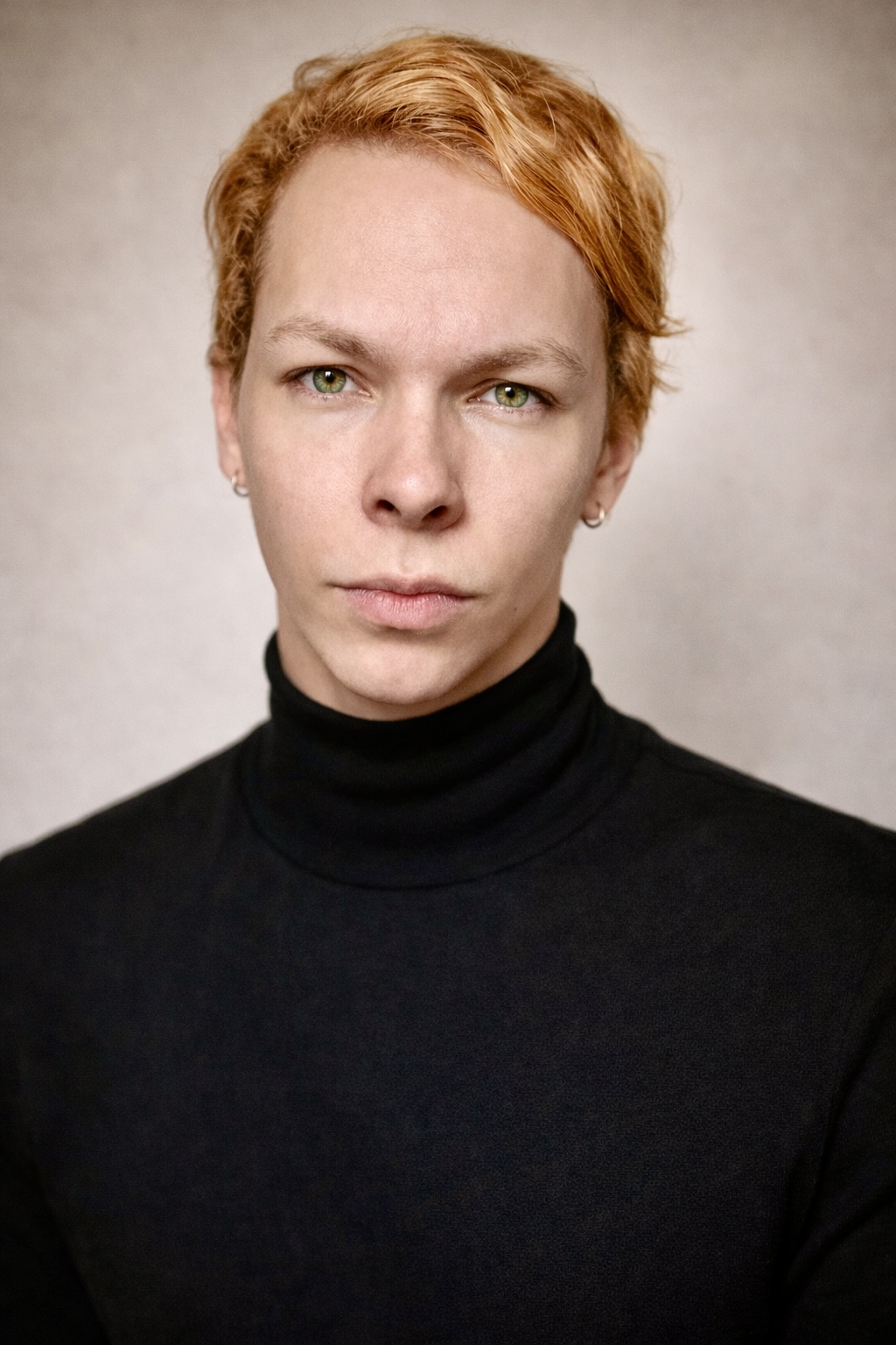Kaelum in a black turtleneck, looking straight into the lens